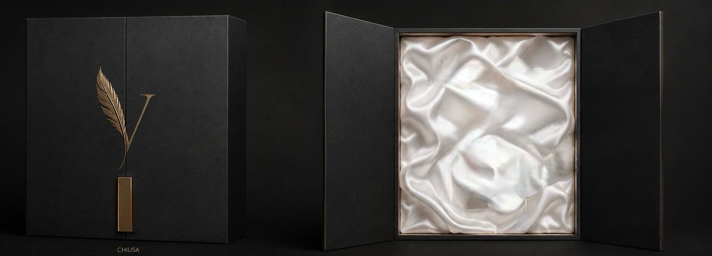 Velvetum rigid black box with gold feather monogram and silk-lined interior